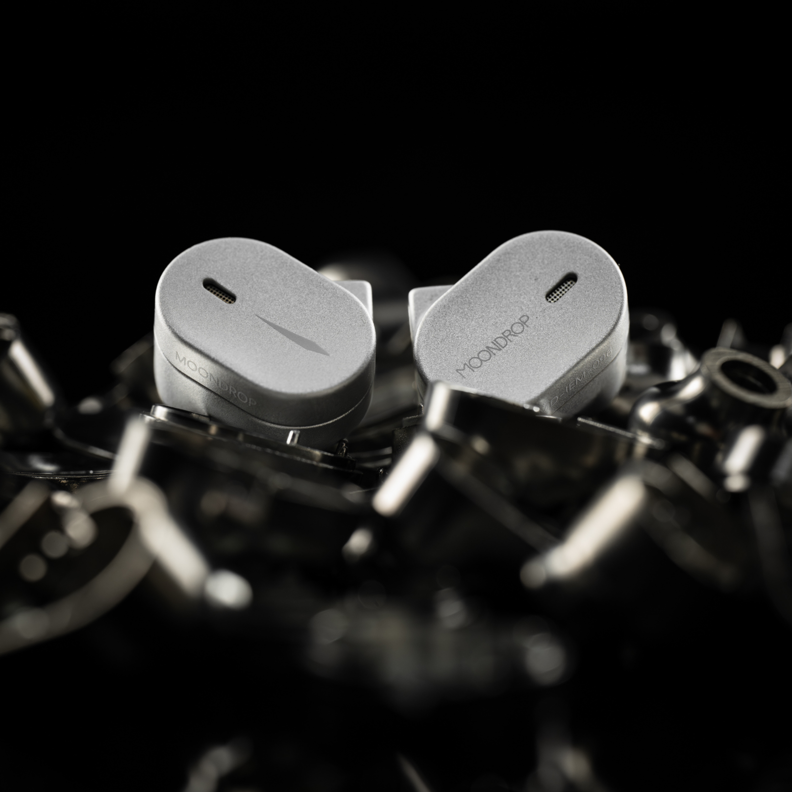 Moondrop CHU III earphones in silver with a metal shell and silver finish, shown on metal components.